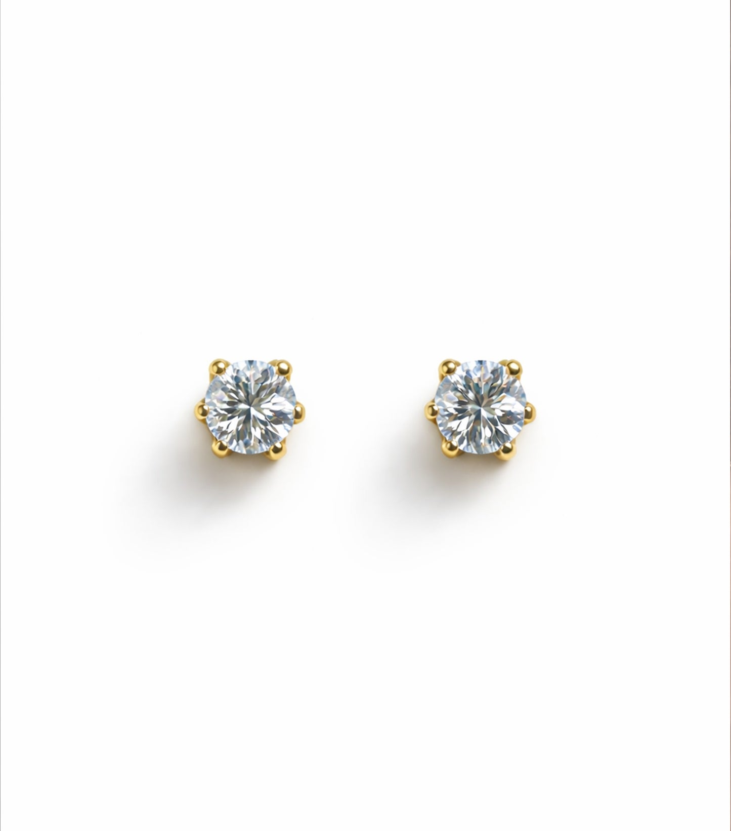 Pair of diamond stud earrings on a white background
