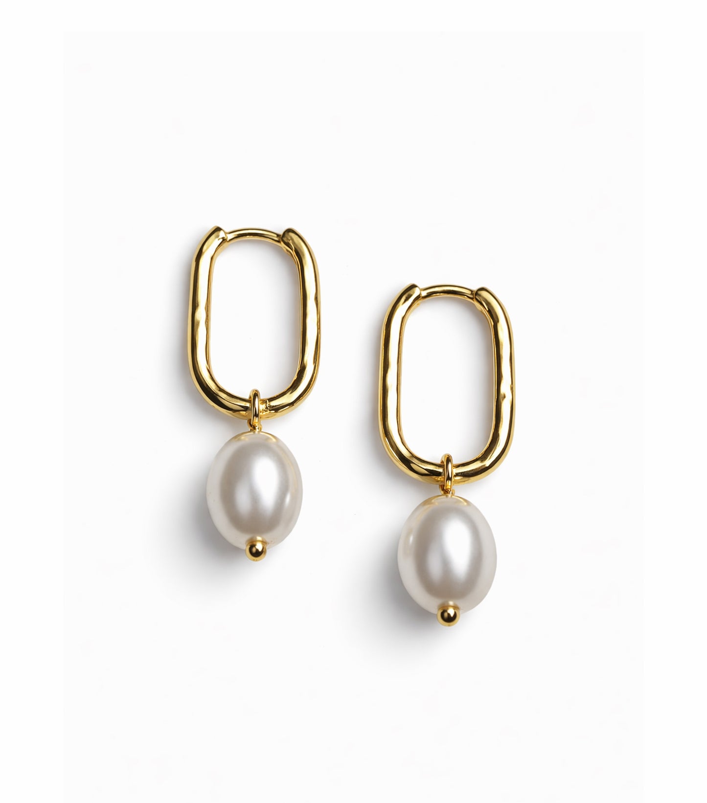 Gold hoop earrings with pearl drops on a white background