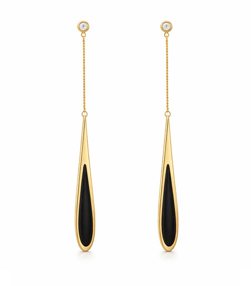 Gold and black drop earrings on a white background