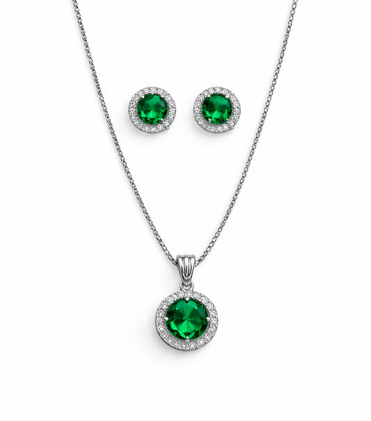 Jewelry set with emerald green gemstones on a white background