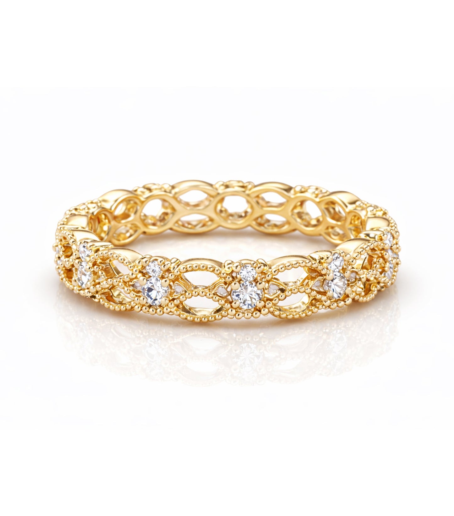 Gold ring with intricate design and embedded diamonds on a white background