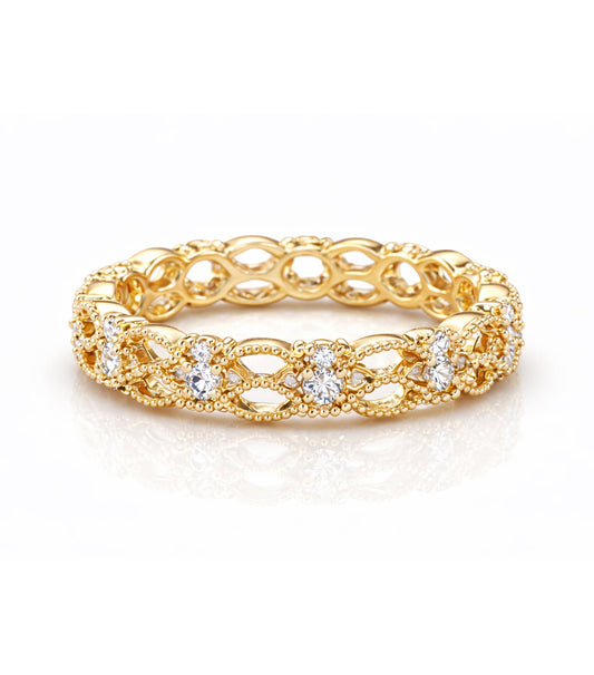 Gold ring with intricate design and embedded diamonds on a white background
