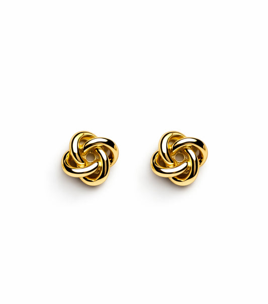 Pair of gold interwoven earrings on a white background