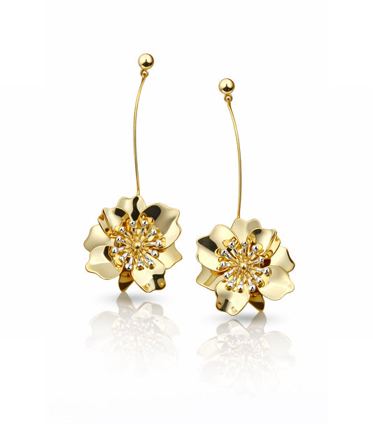 Gold floral earrings on a white background