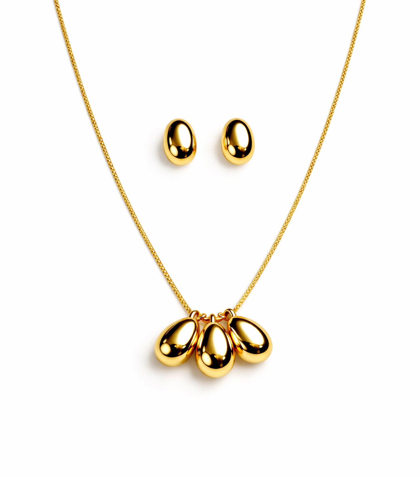 Gold necklace with three teardrop pendants and matching earrings on a white background