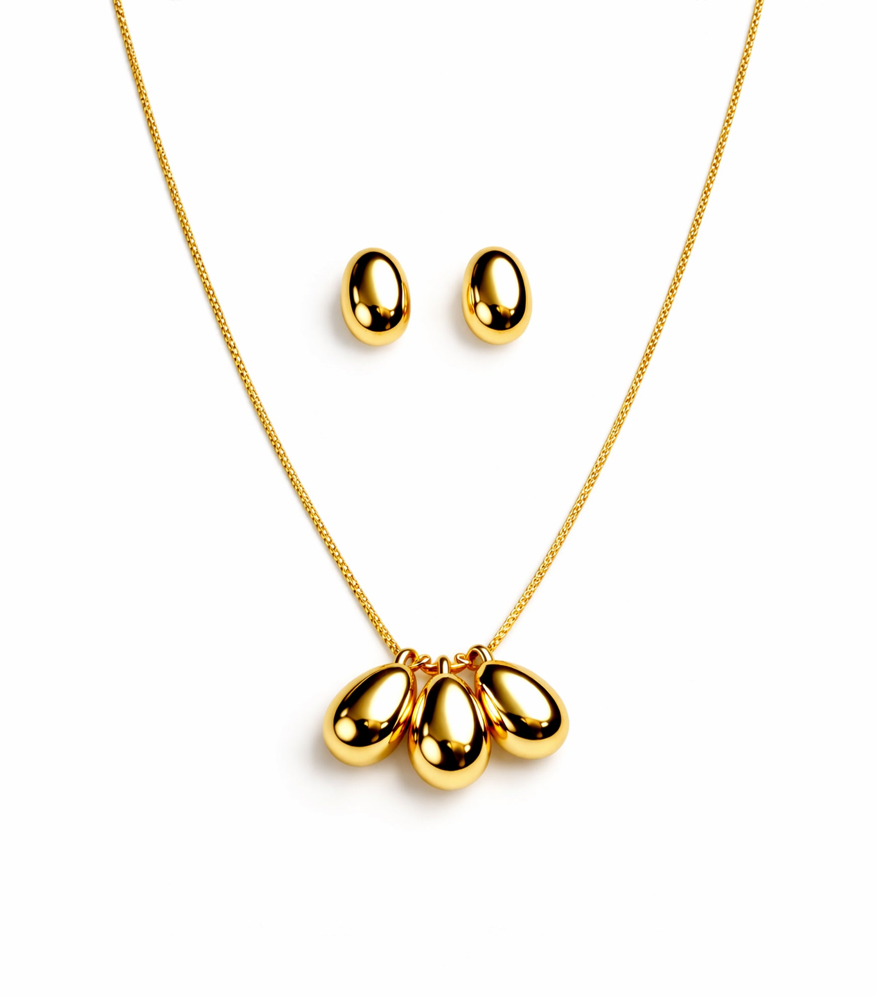 Gold necklace with three teardrop pendants and matching earrings on a white background