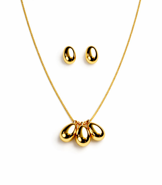 Gold necklace with three teardrop pendants and matching earrings on a white background