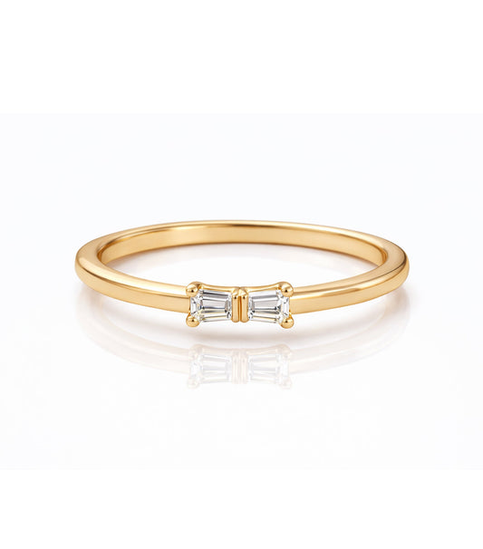Gold ring with two small diamonds on a white background

