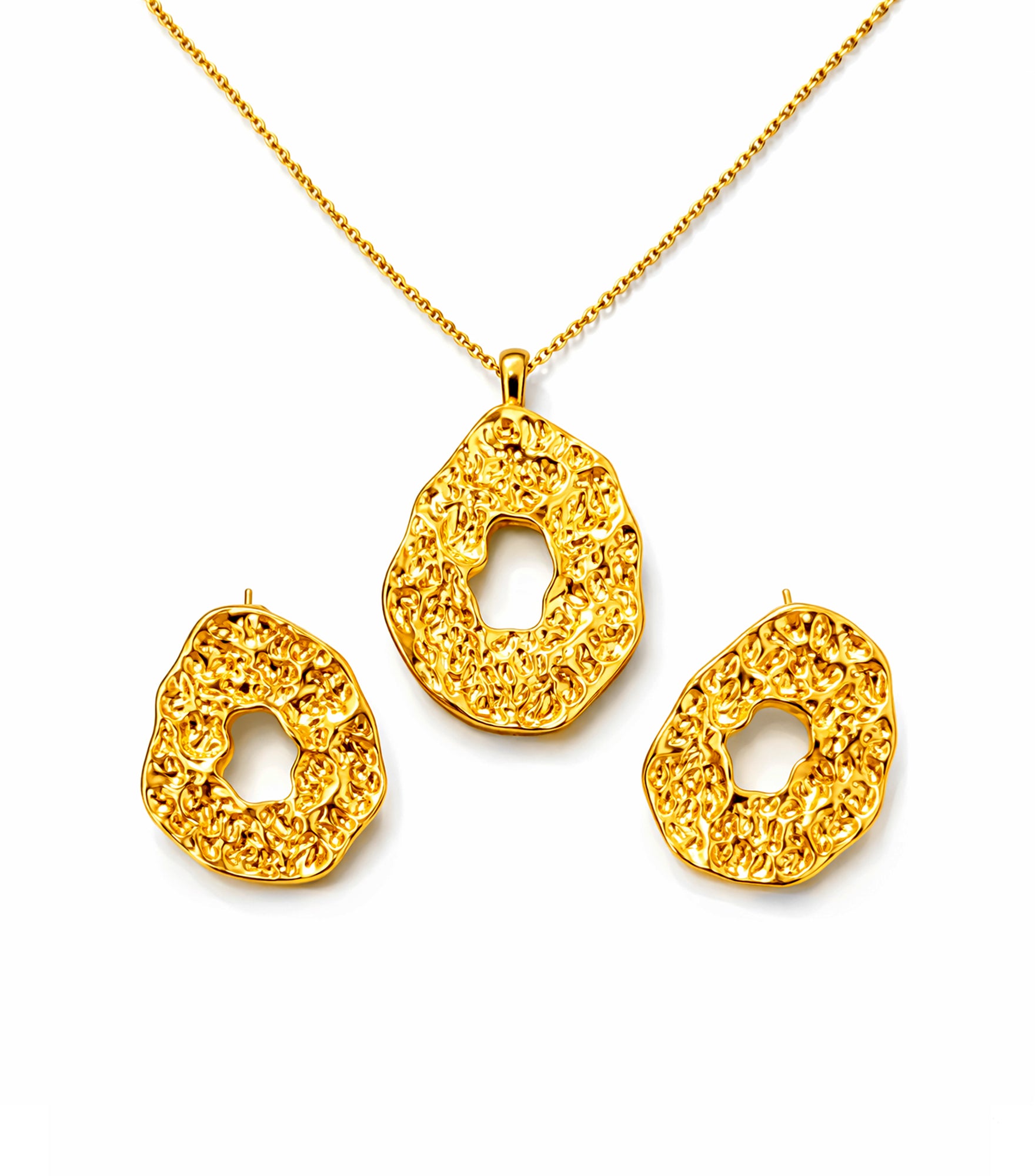 Gold necklace and earrings set on a white background